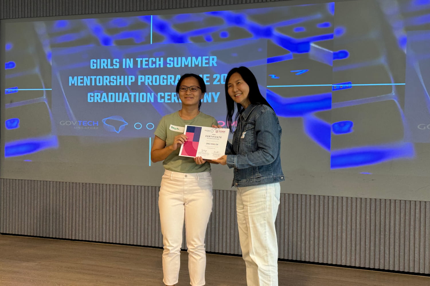 Yong En receiving a certificate of participation in the Girls in Tech summer mentorship programme.